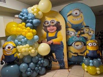 Colorful Minions themed kids birthday balloon decor with custom backdrop in Florida.