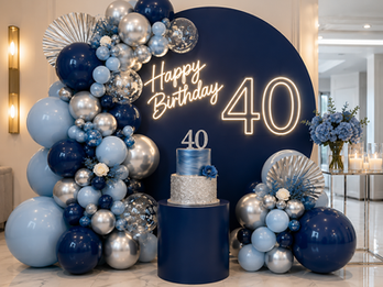 A chic and elegant 40th birthday setup featuring a blue and silver organic balloon garland