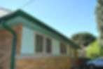 Side roofline with replacement green gutter system on bungalow in Guelph