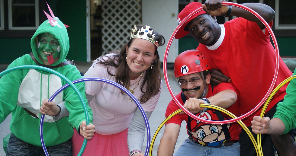 Staff in costumes holding colorful hula hoops