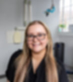 Paige, dental hygienist at Dr. Vultaggio’s Concord MA dental office, professional headshot in scrubs, smiling and providing gentle, patient-focused preventive dental care.