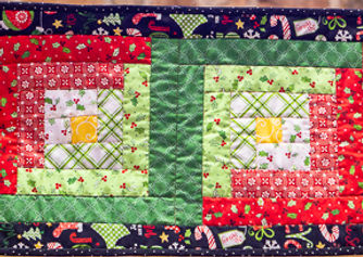 June 25 CQC Laurel Hoppes Log Cabin Table Runner Jingle All the Way Web.jpg