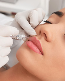 Young woman undergoing procedure of permanent lip makeup in tattoo salon, closeup.jpg