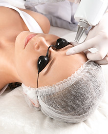Young woman undergoing laser removal of permanent makeup in salon. Eyebrow correction.jpg