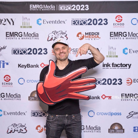 Gary Vee posing with five-hand prop