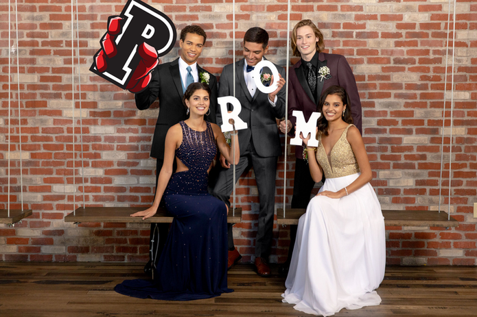 Photo Booth photo of group posing with the Big 'P' prop, along with smaller 'R', 'O', and 'M' props.