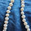 Thumbnail: White pearl necklace on blue background; The Admiral's White South Sea Pearl Set.