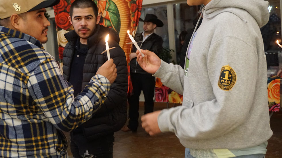 People light candles before a procession to the parish hall at St Paul's Catholic Church during the Our Lady of Guadalupe celebration on Sunday, Dec. 14, 2025. (Ellie Ruel / Juneau Independent)