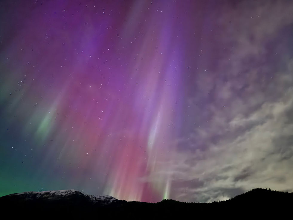 Multicolored bands of northern lights over Thunder Mountain during a geomagnetic storm on Wednesday, Nov. 12, 2025. (Ellie Ruel / Juneau Independent)