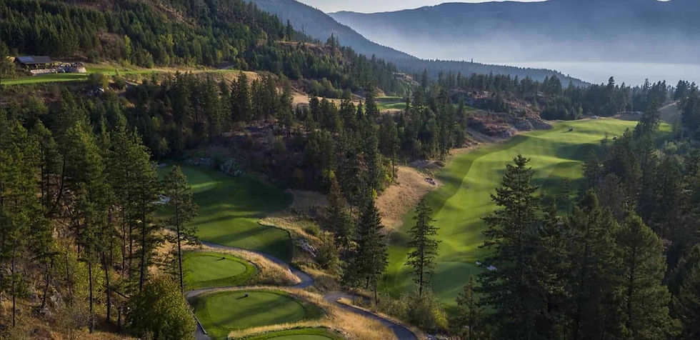 A breathtaking view of the Okanagan Valley at sunset, overlooking the rolling fairways of Predator Ridge Golf Resort in Vernon, BC. The warm golden hues of the setting sun cast a serene glow over the lush landscape, with the mountains in the distance adding to the peaceful beauty of the scene.