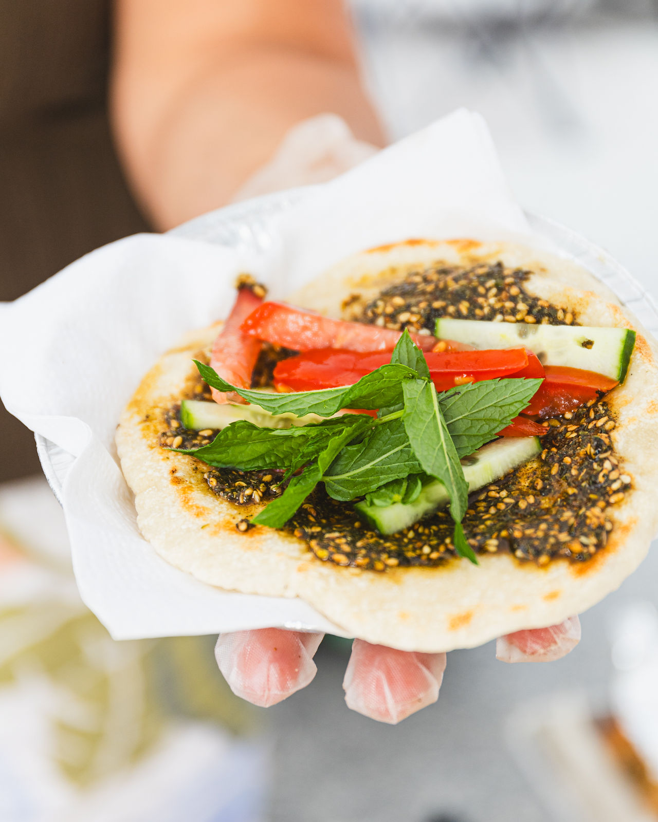 Saj pita topped with za'atar and vegetables