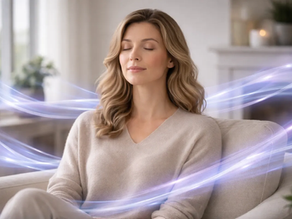 Woman sitting calmly with eyes closed surrounded by flowing energy waves representing frequency technology supporting emotional balance and relaxation