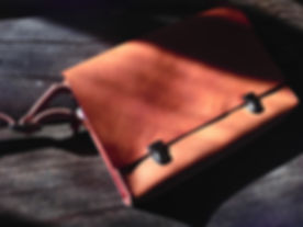 Dark Leather Messenger Bag On Wood