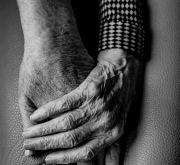 A compassionate hand embracing the hand of a loved one.