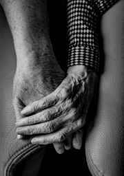 A compassionate hand embracing the hand of a loved one.