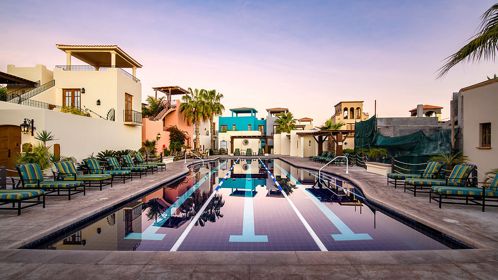 Pretty 3-lane lap pool surrounded by Spanish-Colonial courtyard homes taken during destination resort photoshoot in Loreto Bay, Mexico