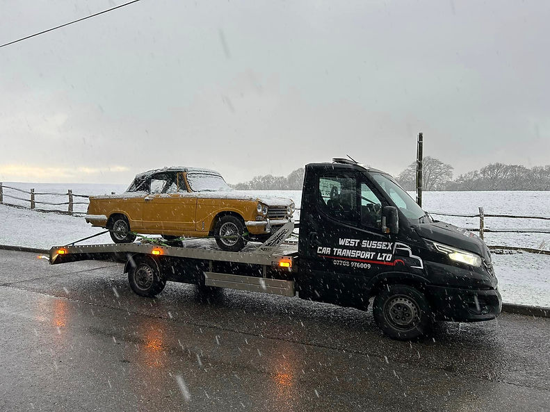blurred image of a yellow car on a tow truck