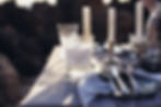 sleek branded candle product amidst an alegant dinner setup, highlighting the product's design and quality, reflecting the brand's premium nature.