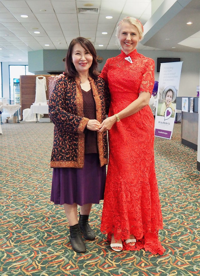 Veronica Lind & Barbara Smith. Barb modeling in Veronica's red wedding dress