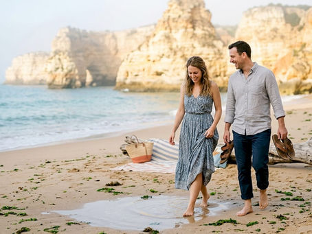 Couple laughing during luxury Algarve beach stroll