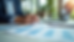 Eye-level view of a consultant reviewing franchise documents on a desk