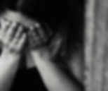 a women holding her head in her hands