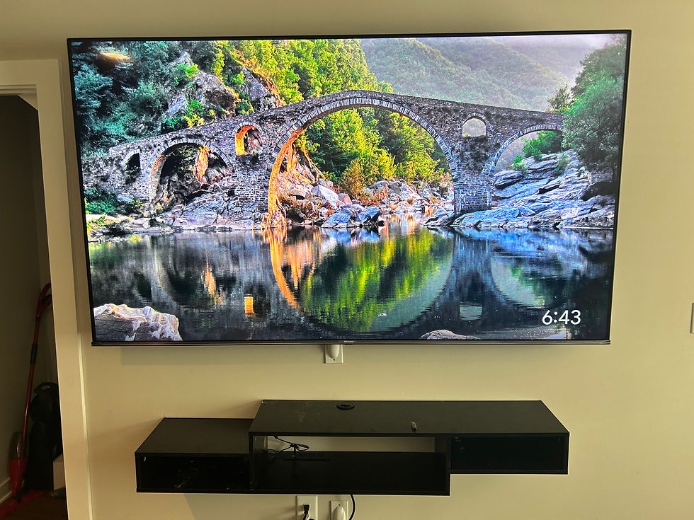 Finished wall-mounted television with a soundbar centered below it
