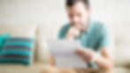 a man reviewing his finanical statements and considering how to manage debt