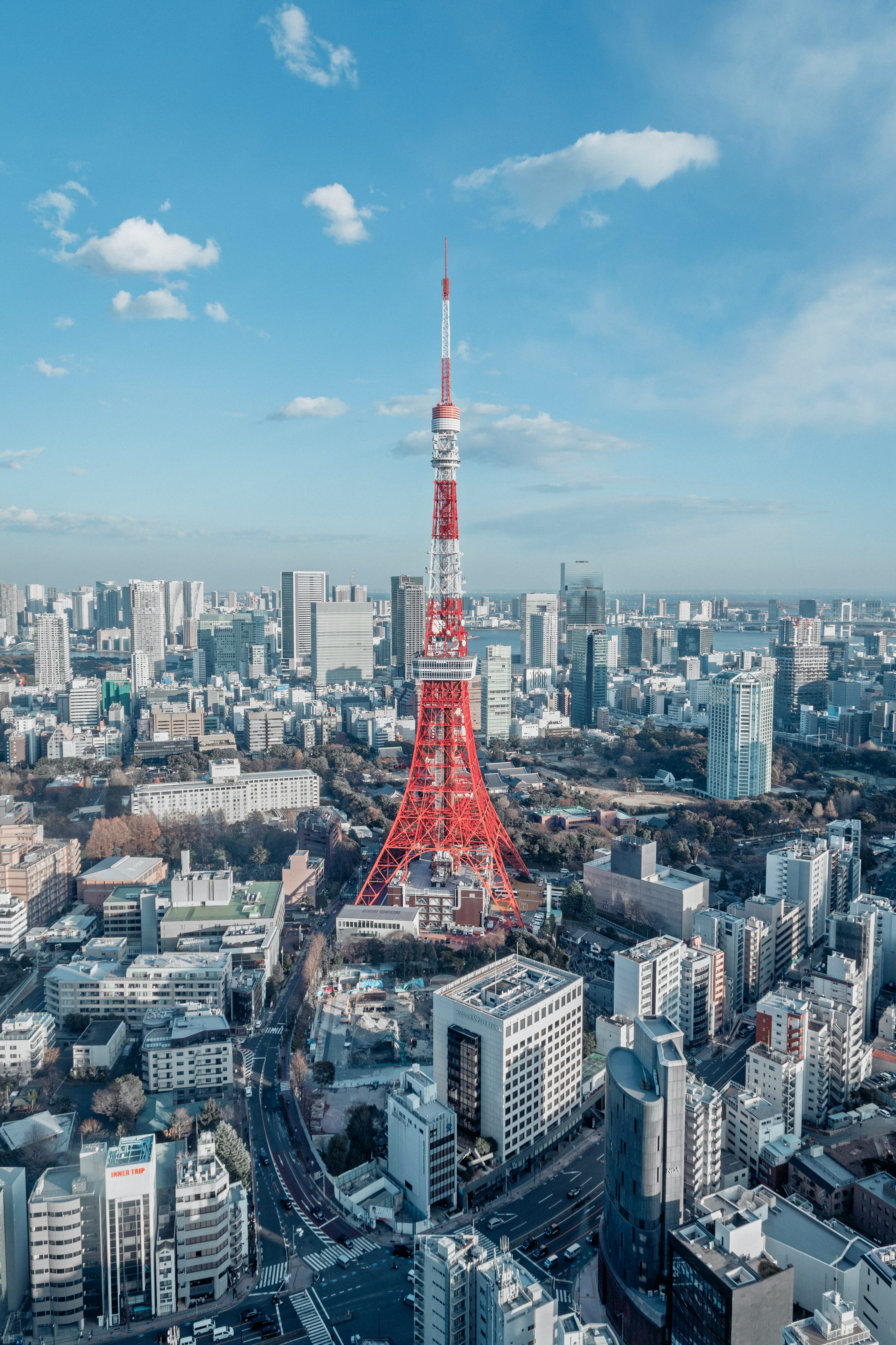 Tokyo Tower and the Tokyo skyline under a blue sky