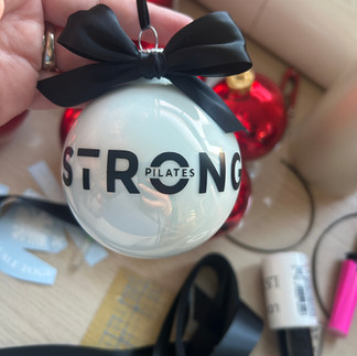 Personalised glass Christmas bauble with company logo Strong Pilates — corporate bespoke order by Petiotes London