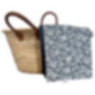 Blue floral waterproof picnic blanket folded against a wicker basket — Indiana print by Petiotes