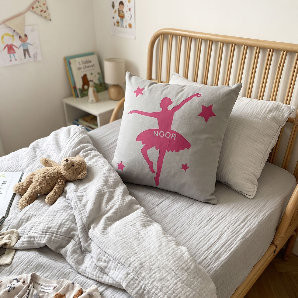 Personalised girl ballerina cushion on wooden toddler bed with soft duvet and teddy bear by Petiotes London