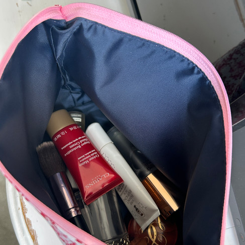 Interior of cotton wash bag showing waterproof lining with makeup brushes and skincare — machine washable wash bag by Petiotes London