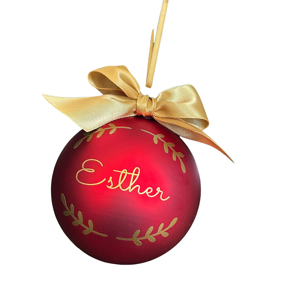 cutout image of a matt red baubles with a personalised gold name and ribbon