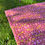 Thumbnail: Dark pink floral picnic blanket on grass with botanical orchid pattern