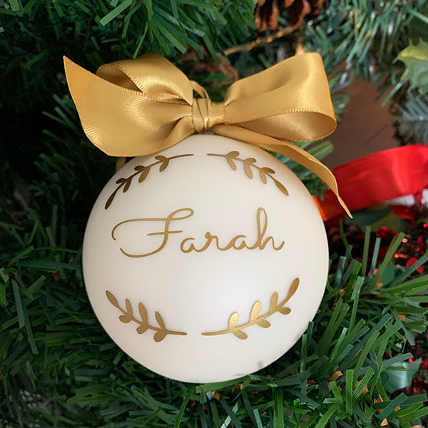Thumbnail: Personalised cream matt glass Christmas bauble with gold ribbon — name Farah — handcrafted in London studio since 2015