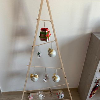 Modern wooden Christmas tree with hanging baubles — creative minimalist decoration idea for small spaces.