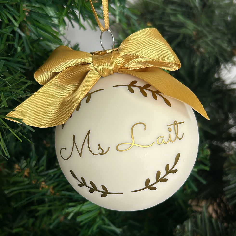 Personalised Christmas glass bauble with gold bow and name inscription, hand-personalised in London