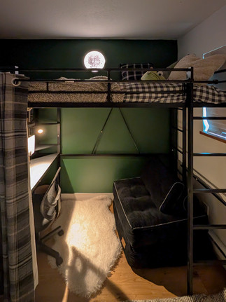 Loft bed in the dark with moon lamp on top and soft light under the bed