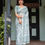 Thumbnail: Woman in Mint Green Linen Saree with detailed floral block print and subtle silver zari border. Daily wear.