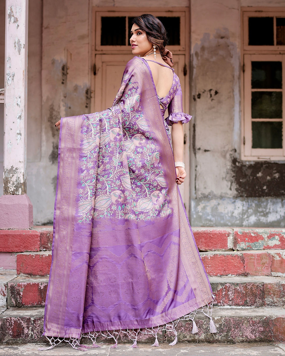 Back view of a woman in a lavender silk saree, showcasing the shimmering zari pallu and all-over woven design