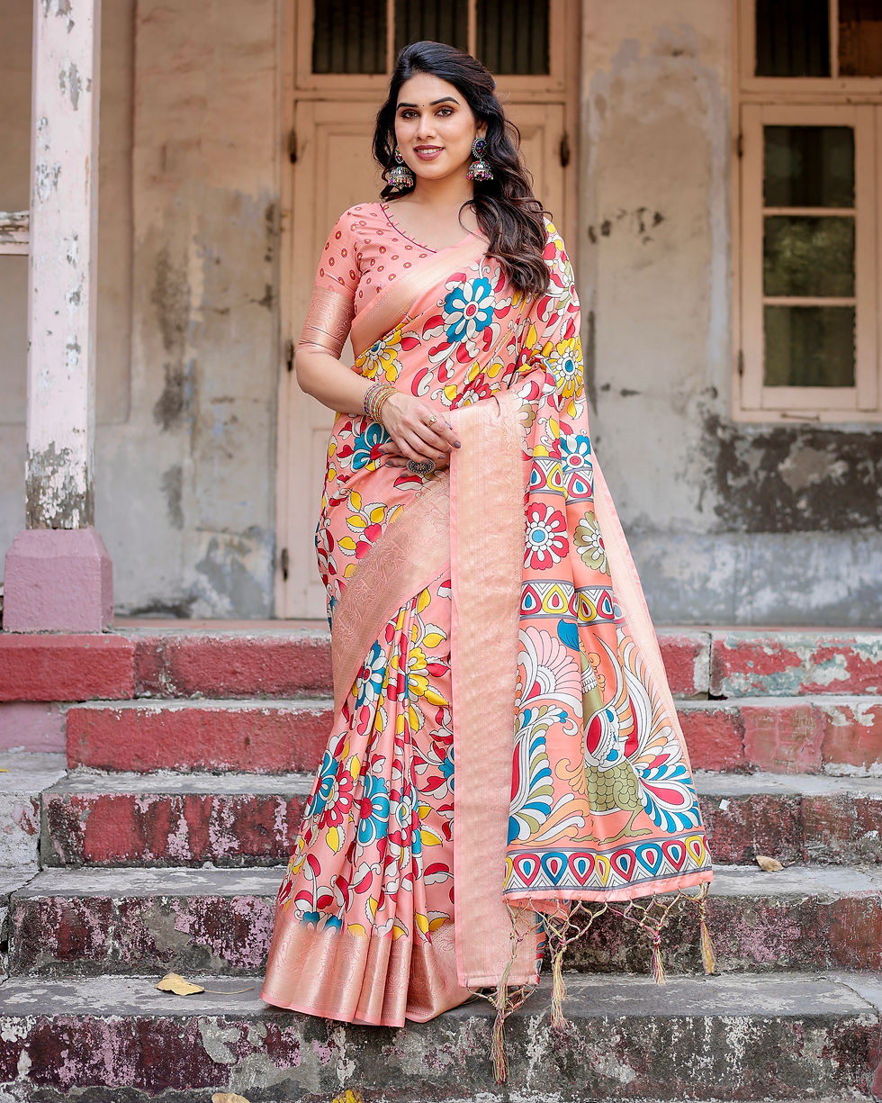 Woman in a peach colored silk saree with vibrant Kalamkari prints and a rose gold border standing on steps.