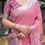 Thumbnail: Close-up of a premium pink linen saree showcasing the silver woven border and traditional art prints on the pallu.