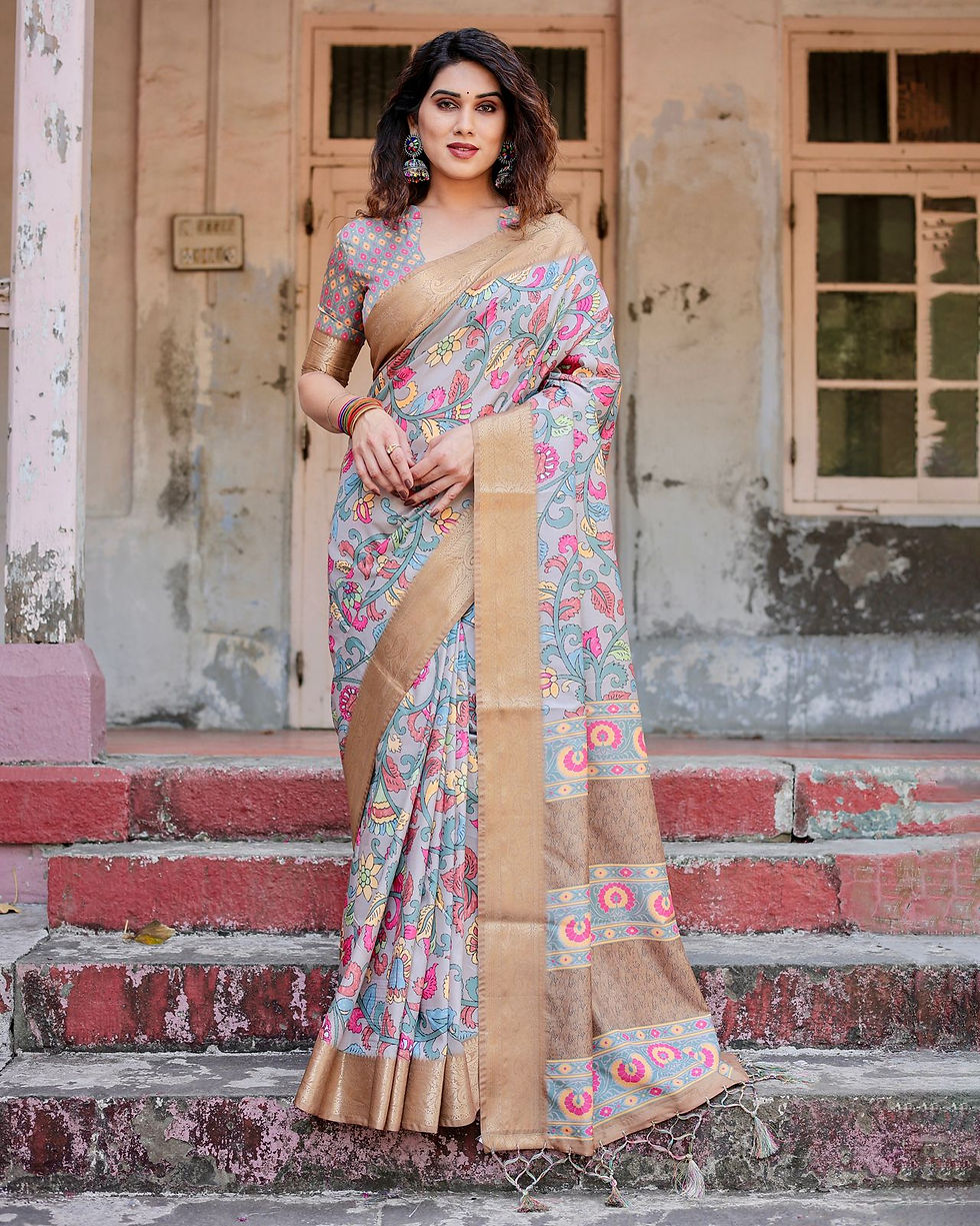 Woman in a Grey Silk Saree with pastel Kalamkari floral prints and a heavy gold Banarasi border. Festive wear.