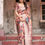 Thumbnail: Woman in a premium silk saree featuring a rich multi-color animal and floral print with an elegant mauve border