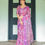 Thumbnail: Full view of a woman in an elegant designer pink and purple saree with a shimmering woven border for festive wear.