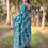 Thumbnail: Back view of Teal Blue Saree highlighting the floral and geometric patterned pallu with elegant tassels.