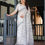 Thumbnail: Woman in a White Linen Saree with grey Warli Art print and tribal motif border. Shop daily wear sarees.