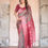 Thumbnail: Woman in a gorgeous gray and black printed silk saree with a wide, rich maroon woven Banarasi border.