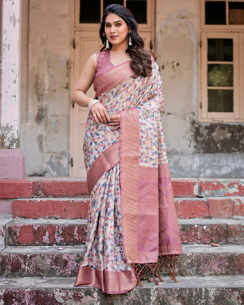 Woman in a premium silk saree featuring an abstract triangular print and a wide shimmering rose-pink border.